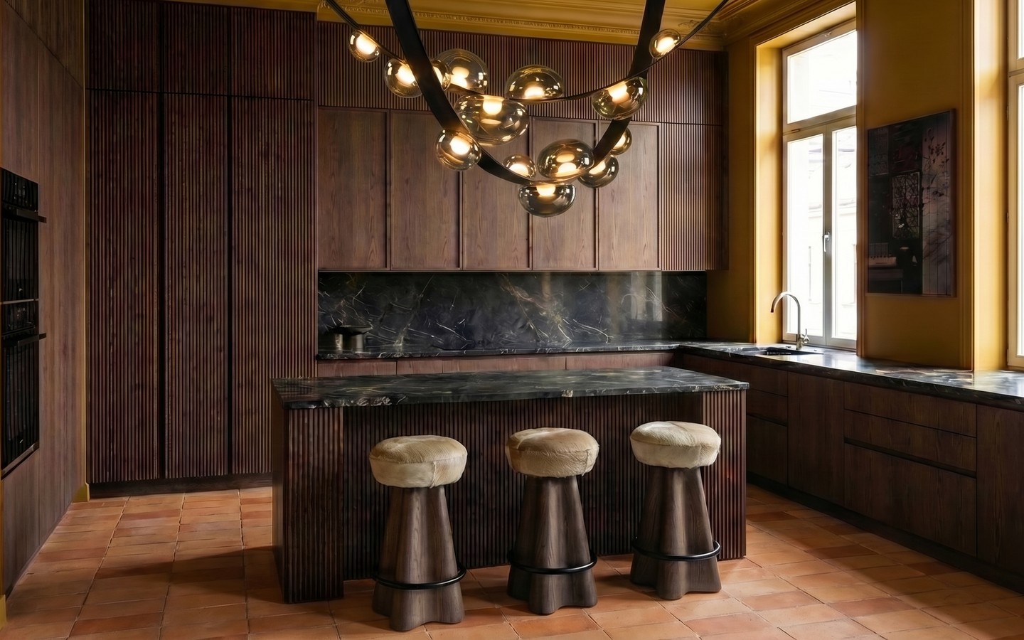 Collected kitchen interior with dark wood, mustard walls and sculptural lighting